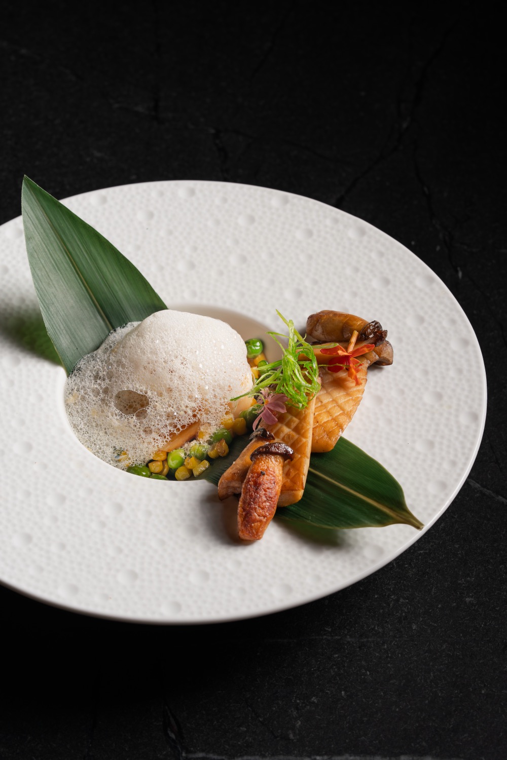 Black cod with miso glaze, sweet corn and peas under a light foam